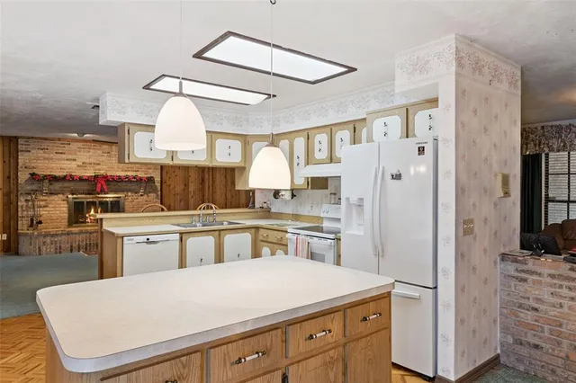 a kitchen with refrigerator cabinets and a sink