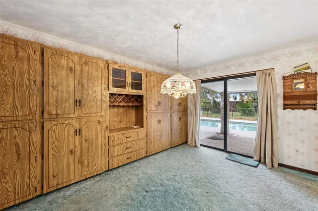 a living room with a bed and a chandelier