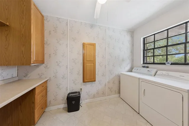 a view of a house with swimming pool and a yard