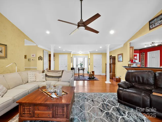 a living room with furniture and wooden floor