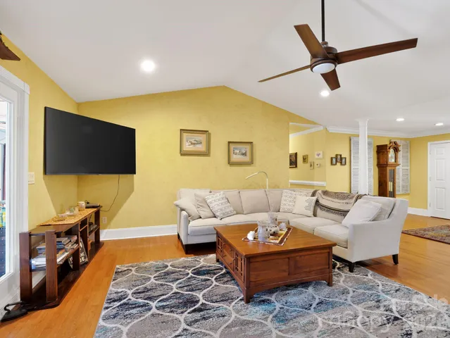a living room with furniture and a flat screen tv