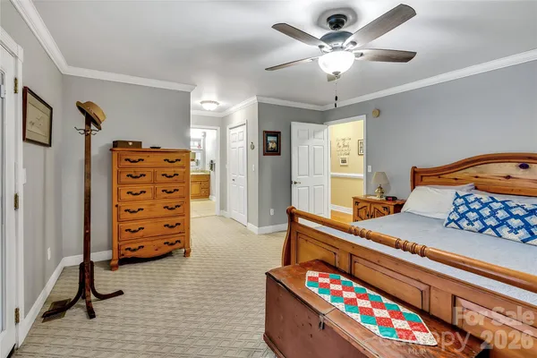a bedroom with furniture and a baby crib