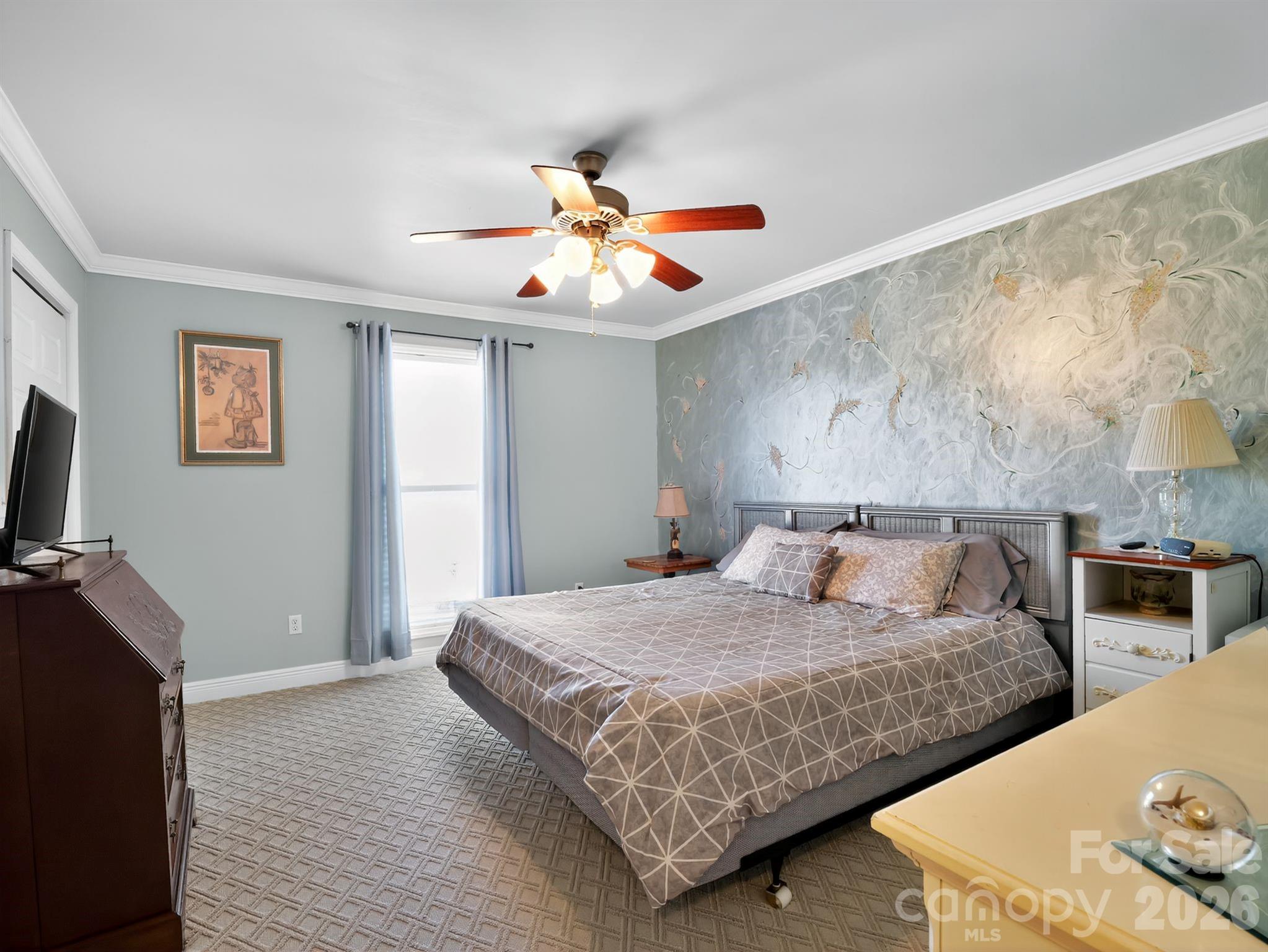 1035 McMillan Road Cheraw, SC 29520 - Photo 19 of 30 a bedroom with a bed and a chandelier