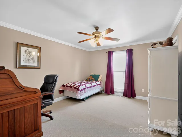 a bedroom with furniture and a chandelier