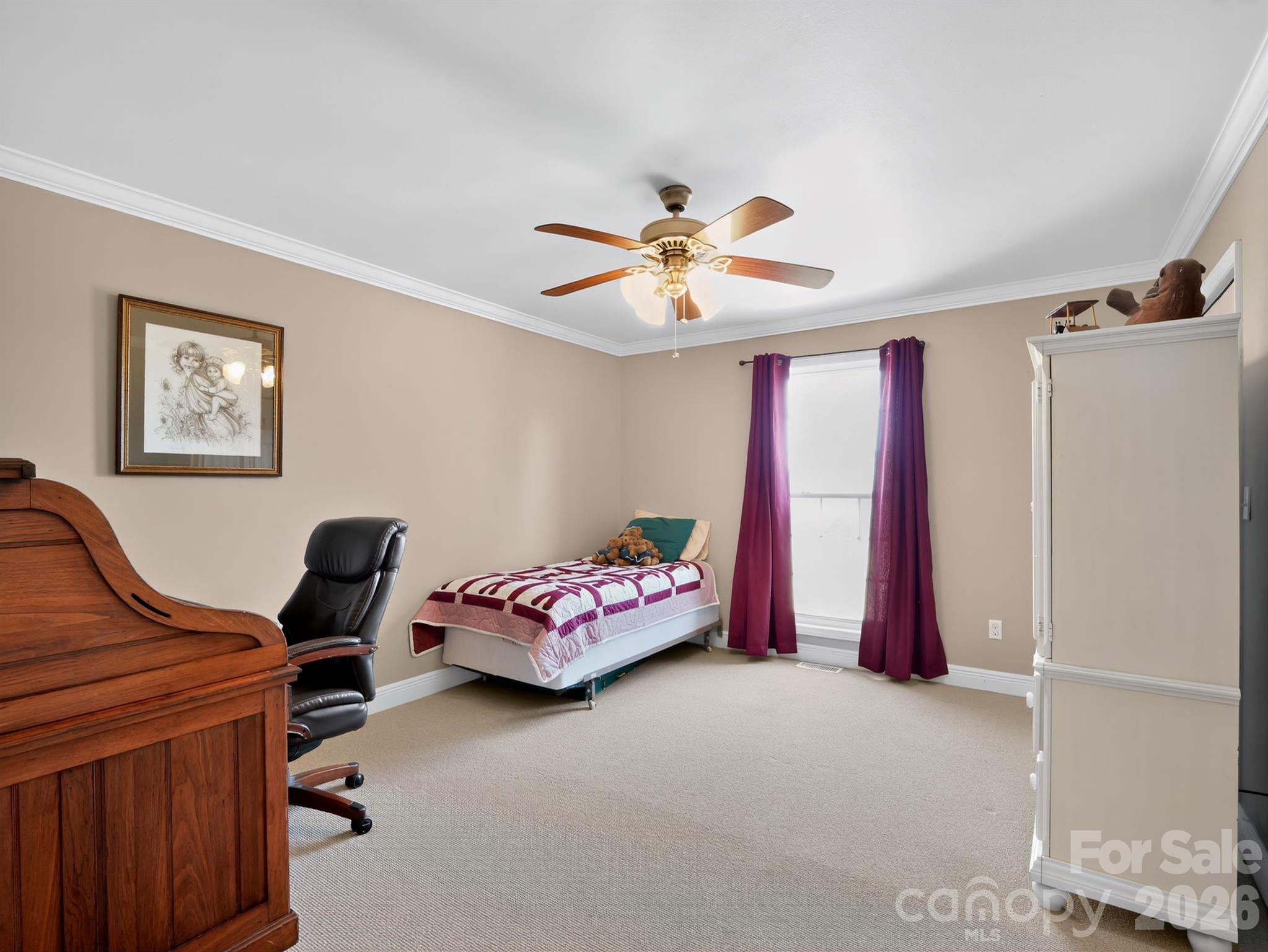 1035 McMillan Road Cheraw, SC 29520 - Photo 20 of 30 a bedroom with furniture and a chandelier