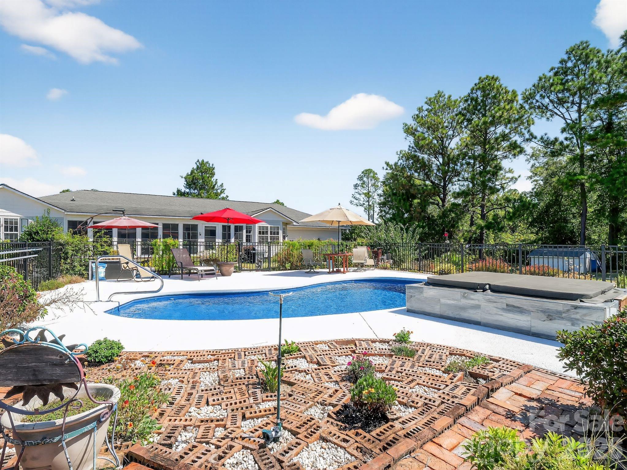 1035 McMillan Road Cheraw, SC 29520 - Photo 2 of 30 a view of swimming pool with seating space and trees in the background