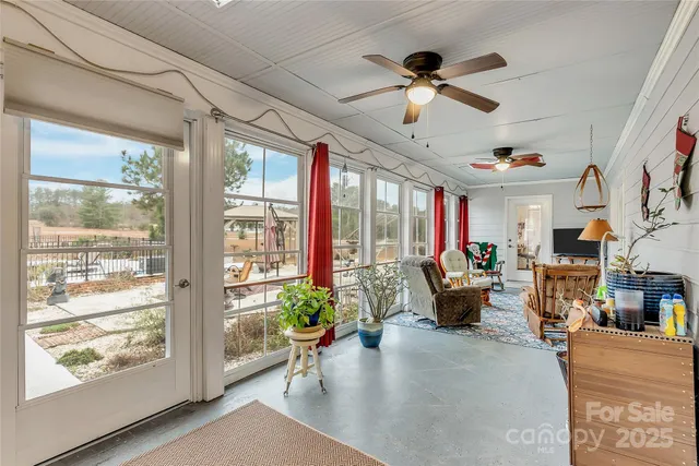 a living room with patio furniture and a large window