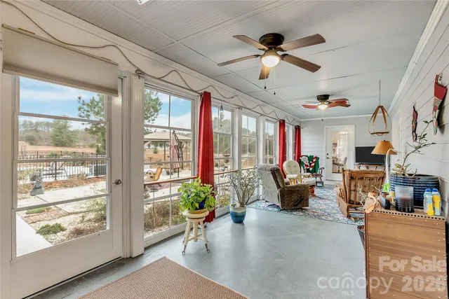 a living room with patio furniture and a large window