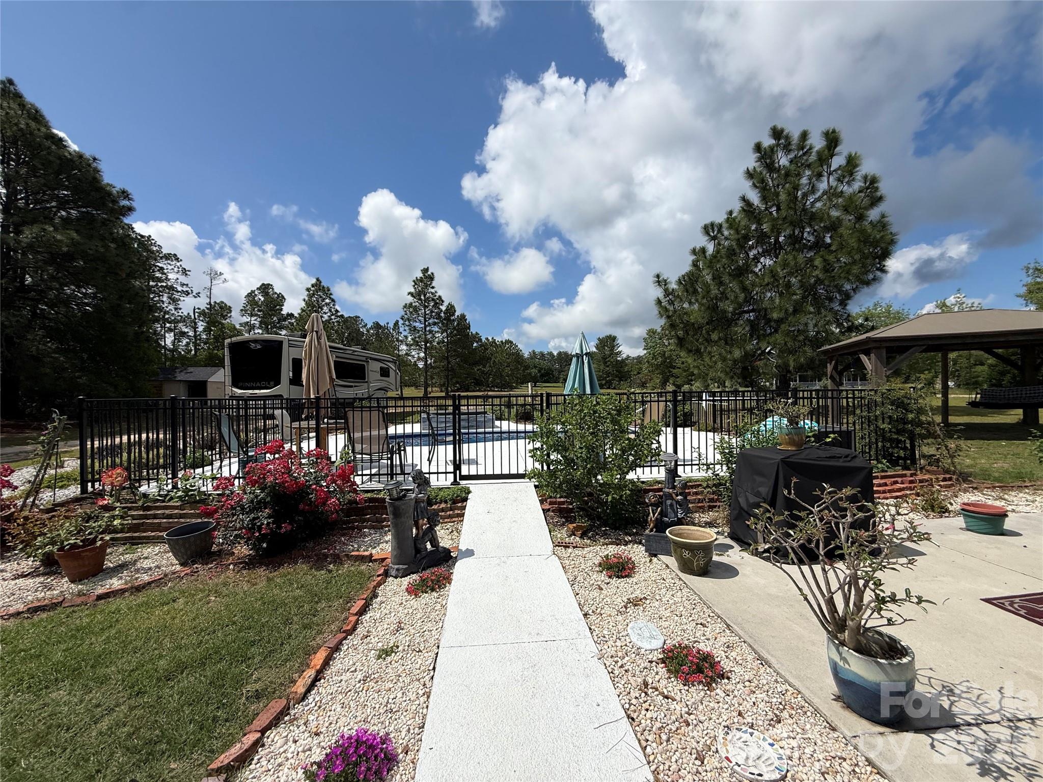 1035 McMillan Road Cheraw, SC 29520 - Photo 23 of 30 a view of a patio with table and chairs and potted plants