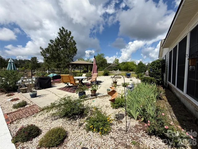 a view of a backyard with sitting area
