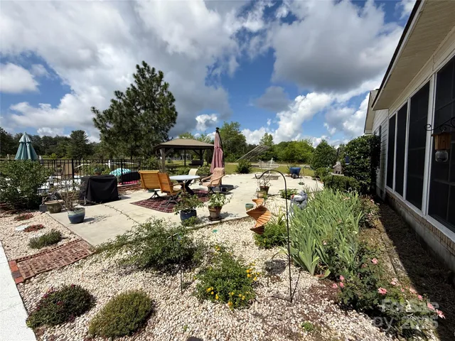 a view of a backyard with sitting area