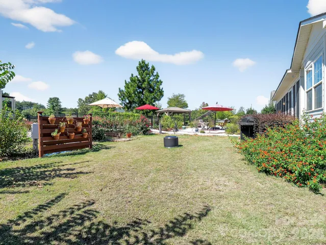 a view of yard with swimming pool and green space