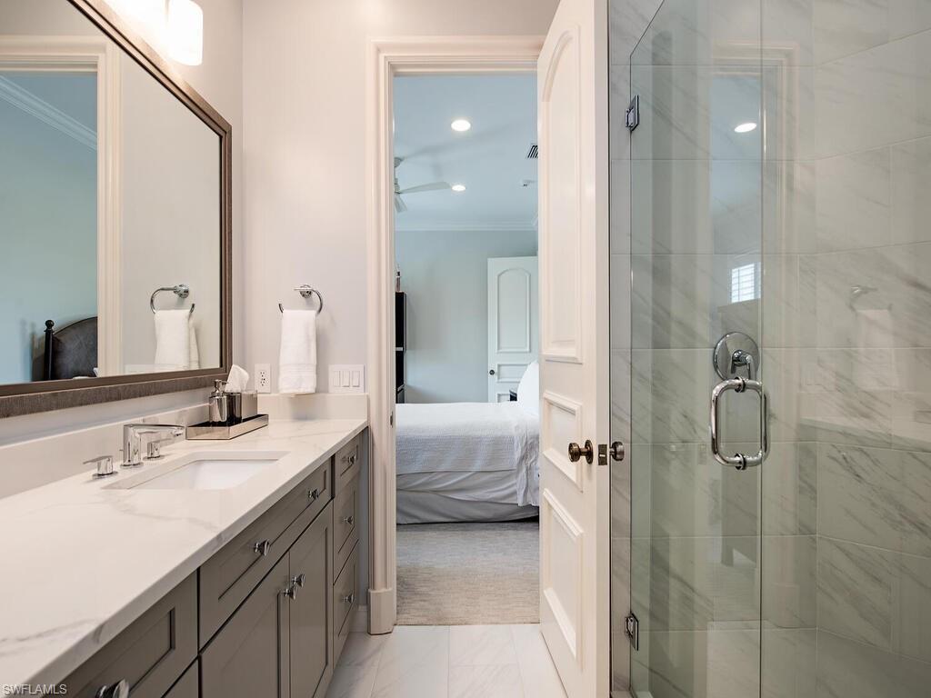 Xxx Lantern Lane Naples, FL 34102 - Photo 13 of 21 a en suite bathroom with a double vanity sink a mirror and a shower