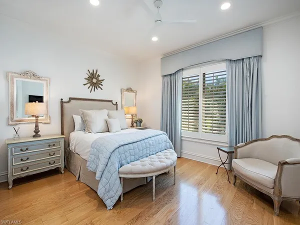 a spacious bedroom with a bed and a couch