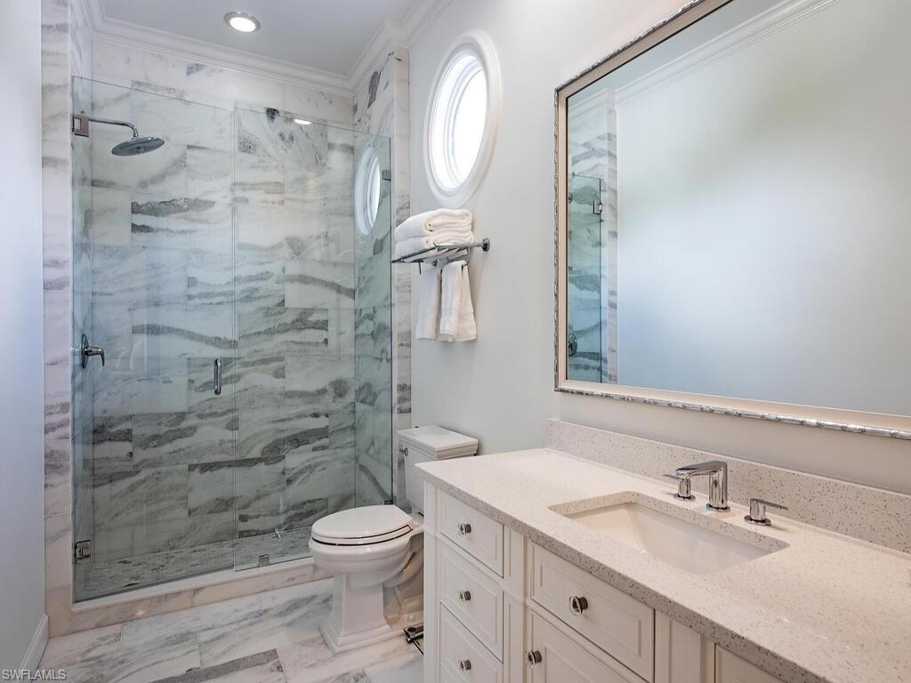 Xxx Lantern Lane Naples, FL 34102 - Photo 16 of 21 a bathroom with a granite countertop sink toilet a mirror and shower