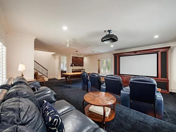 a living room with furniture ceiling fan and a window