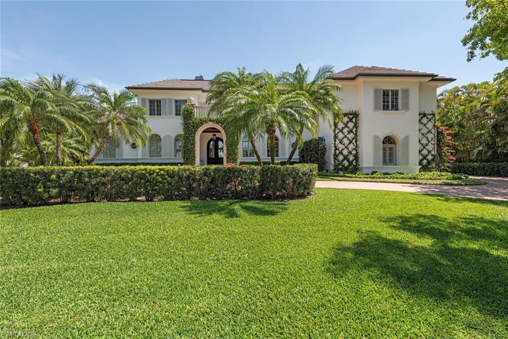 Xxx Lantern Lane Naples, FL 34102 - Photo 18 of 21 a front view of a house with a garden