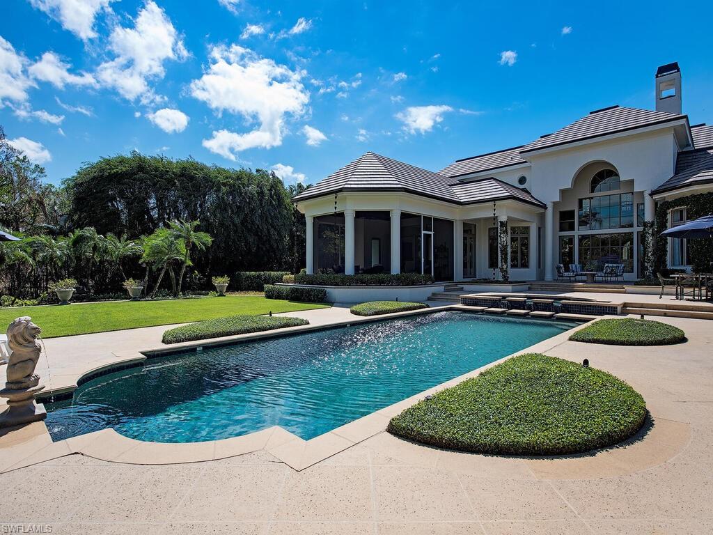 Xxx Lantern Lane Naples, FL 34102 - Photo 21 of 21 a view of a house with swimming pool and a yard