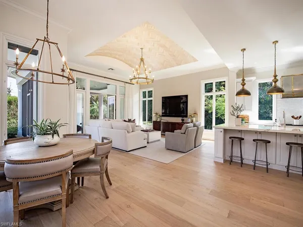 a living room with furniture a flat screen tv and a large window