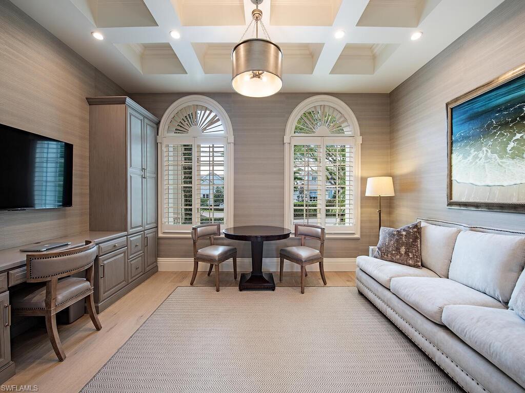 Xxx Lantern Lane Naples, FL 34102 - Photo 8 of 21 a living room with fireplace furniture and a flat screen tv