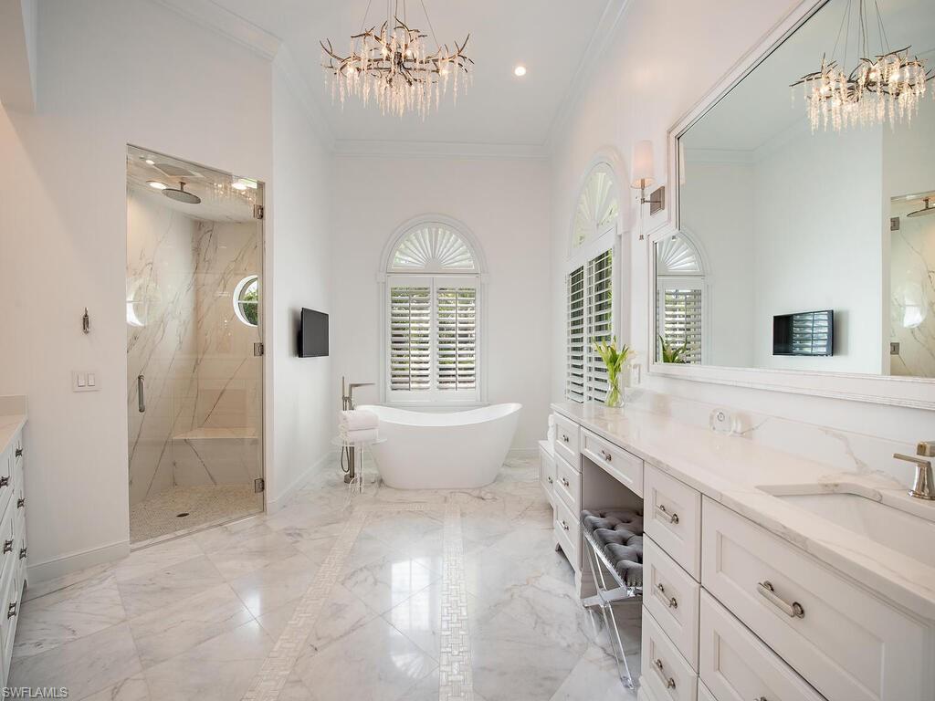 Xxx Lantern Lane Naples, FL 34102 - Photo 9 of 21 a spacious bathroom with a tub sink and mirror
