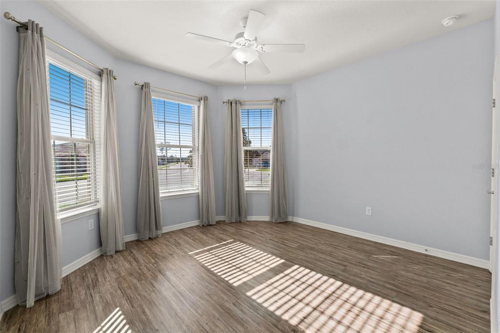 12653 Palapa Loop Spring Hill, FL 34610 - Photo 12 of 50 a view of an empty room with window and wooden floor