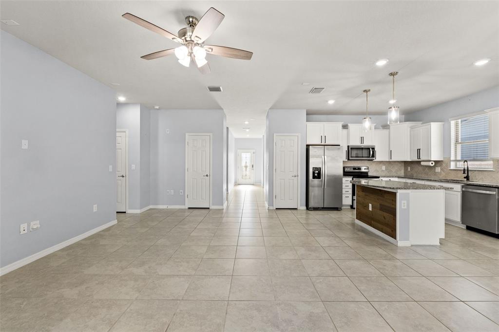 12653 Palapa Loop Spring Hill, FL 34610 - Photo 21 of 50 a large kitchen with stainless steel appliances a refrigerator a sink dishwasher with a cabinets and a refrigerator