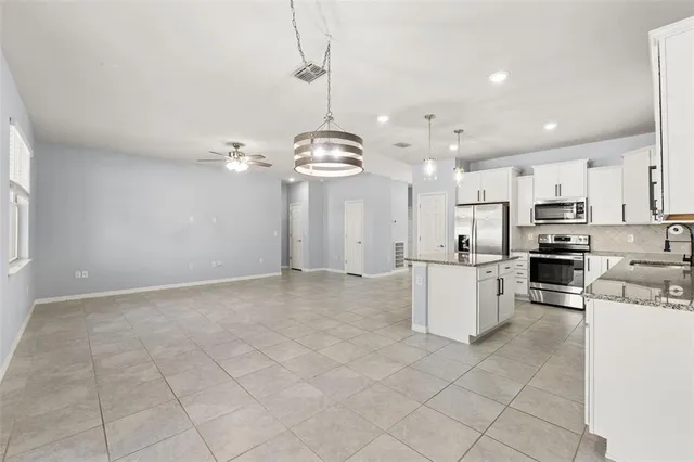 a view of a kitchen with microwave and cabinets