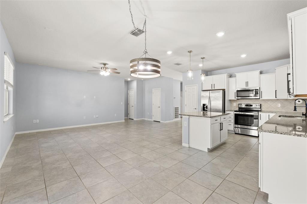 12653 Palapa Loop Spring Hill, FL 34610 - Photo 22 of 50 a view of a kitchen with microwave and cabinets