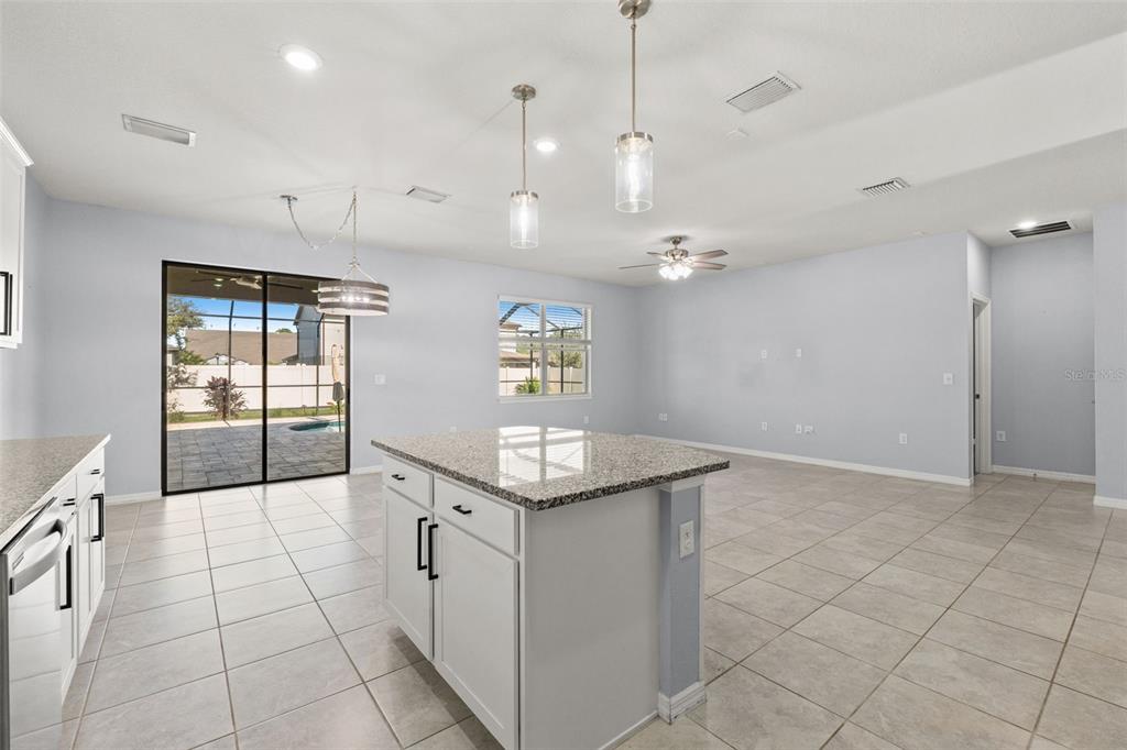 12653 Palapa Loop Spring Hill, FL 34610 - Photo 24 of 50 a bathroom with a granite countertop sink a large mirror and a shower