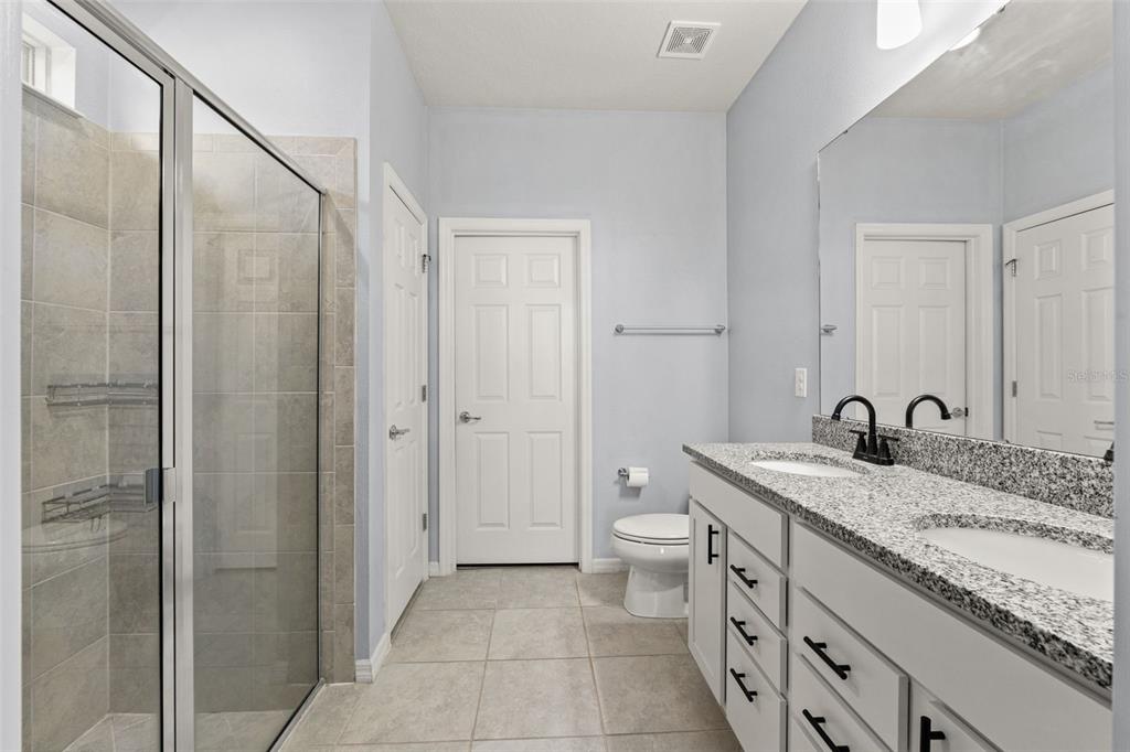 12653 Palapa Loop Spring Hill, FL 34610 - Photo 27 of 50 a bathroom with a granite countertop sink and a mirror