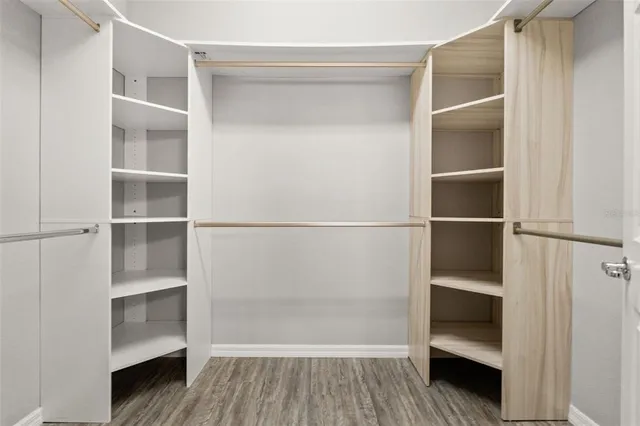 a view of walk in closet with empty racks