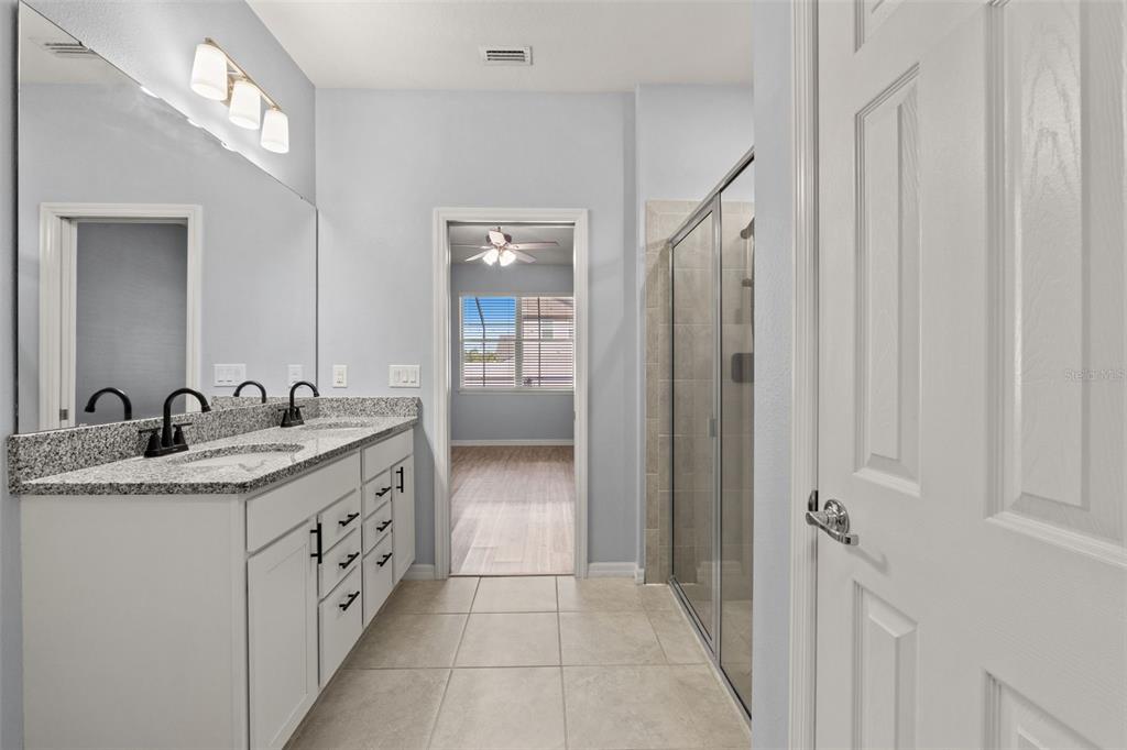 12653 Palapa Loop Spring Hill, FL 34610 - Photo 30 of 50 a bathroom with a granite countertop sink and a mirror