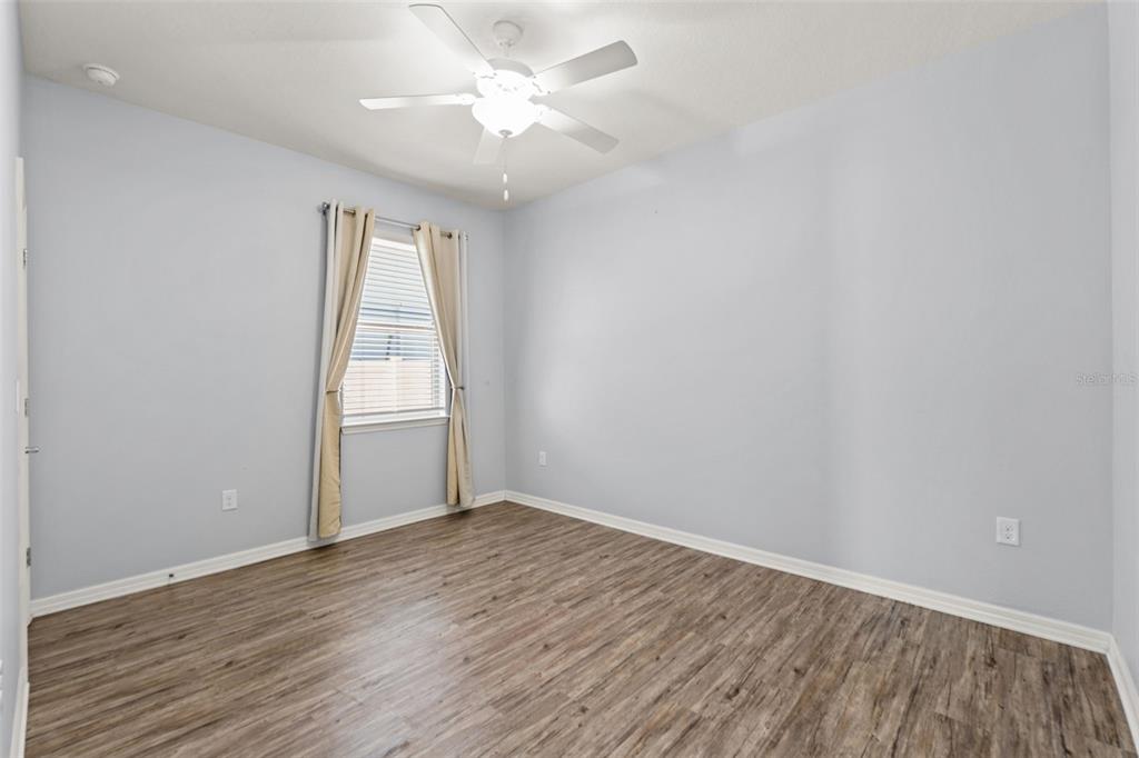 12653 Palapa Loop Spring Hill, FL 34610 - Photo 8 of 50 a view of an empty room with wooden floor and a window