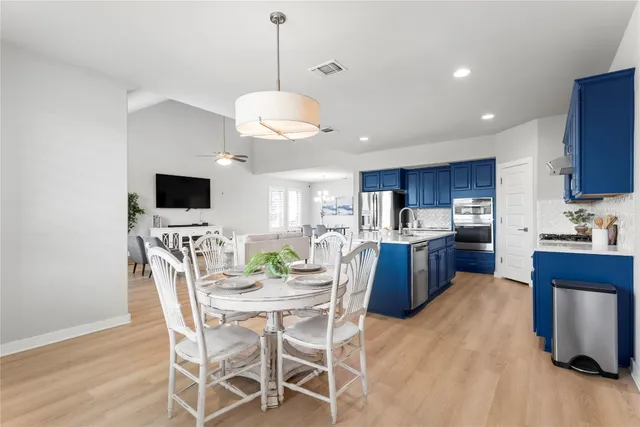 a kitchen with stainless steel appliances granite countertop a sink dishwasher stove and cabinets