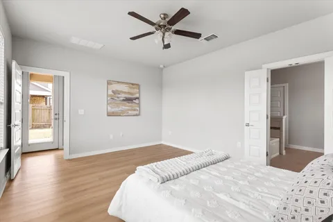 a kitchen with stainless steel appliances kitchen island granite countertop a sink a stove a dining table and chairs with wooden floor