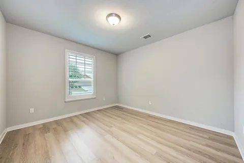 a view of a room with wooden floor