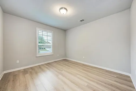 a view of a room with wooden floor