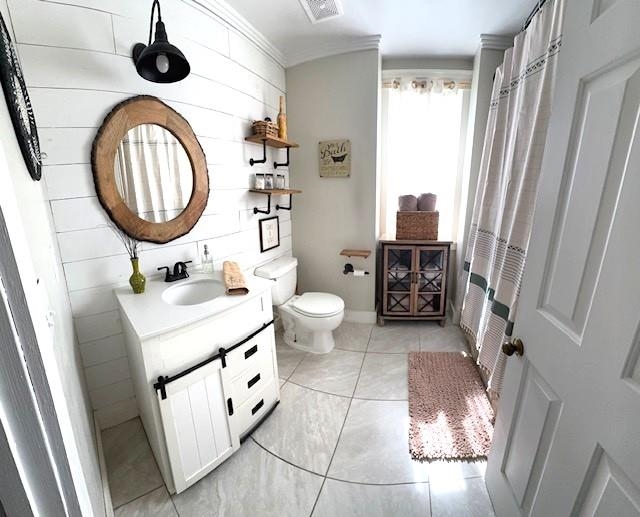 1897 Corbin Road Germantown, TN 38139 - Photo 11 of 22 Bathroom featuring a white vanity with sliding barn door accent, contemporary black faucet, and a round wood-finish mirror