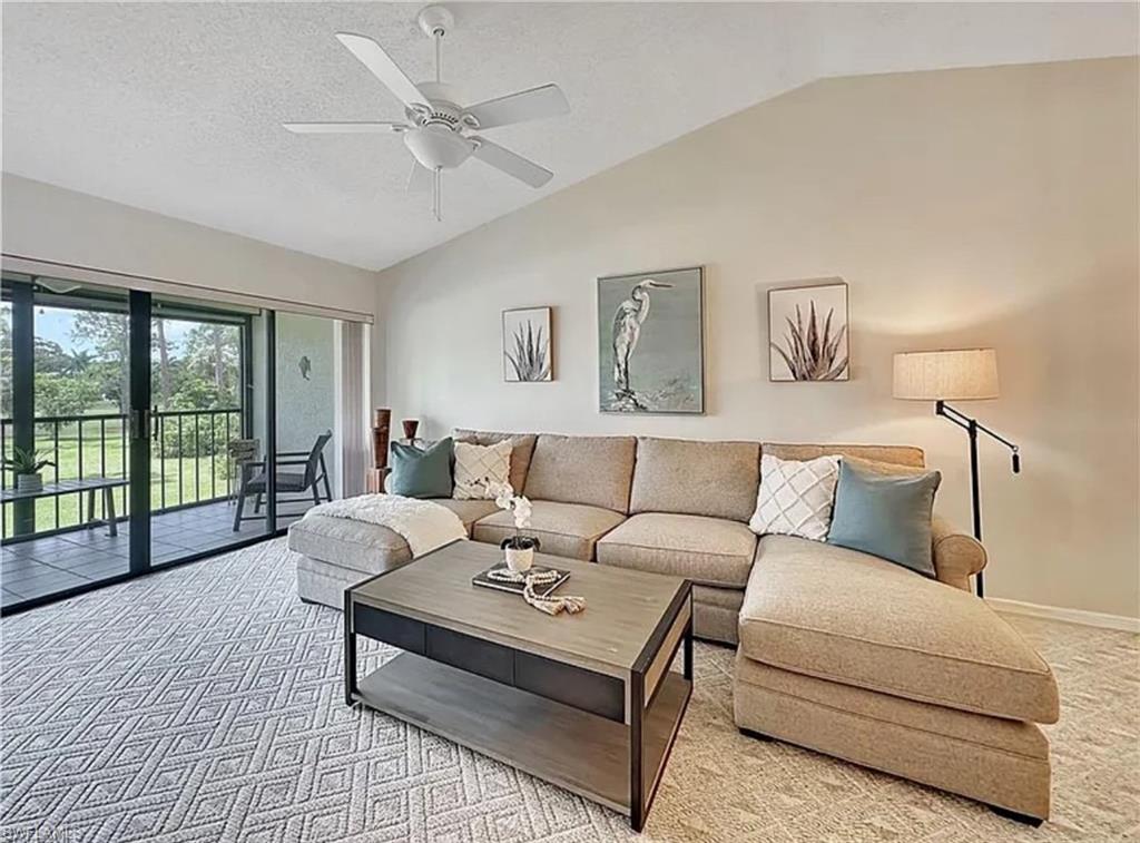 905 Augusta Boulevard Naples, FL 34113 - Photo 11 of 20 a living room with furniture and large windows