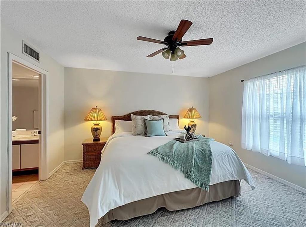 905 Augusta Boulevard Naples, FL 34113 - Photo 14 of 20 a bedroom with a bed and window