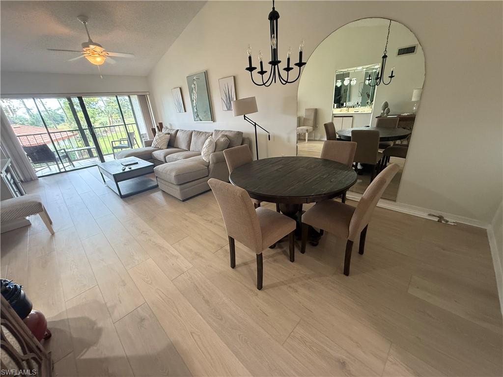 905 Augusta Boulevard Naples, FL 34113 - Photo 7 of 20 a living room with furniture and a chandelier