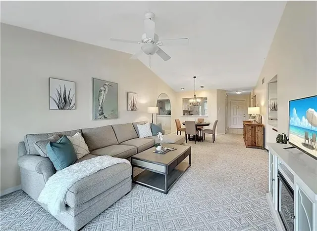 a view of a dining room with furniture and chandelier