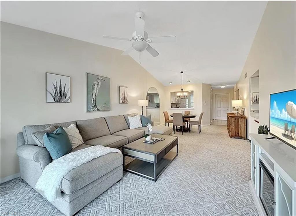 905 Augusta Boulevard Naples, FL 34113 - Photo 8 of 20 a living room with furniture kitchen view and a flat screen tv