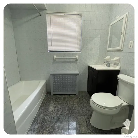 a bathroom with a toilet a sink and bathtub