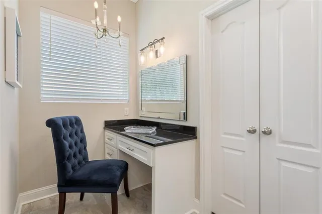 a spacious bathroom with a granite countertop sink and a mirror