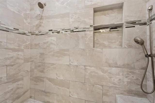 a bathroom with a bathtub and a shower