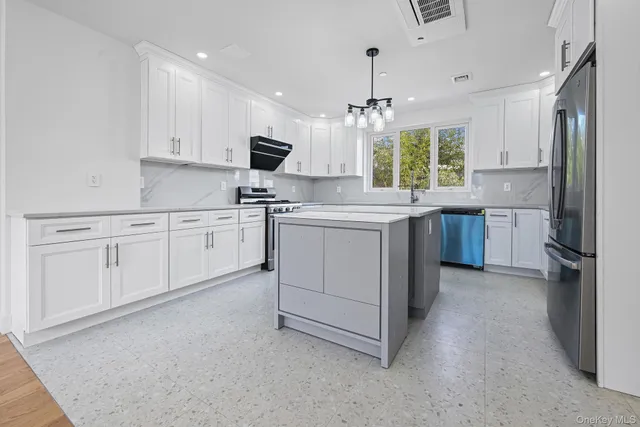 a kitchen with a white cabinets stove and refrigerator