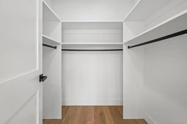 a bathroom with a sink a toilet a mirror and shower