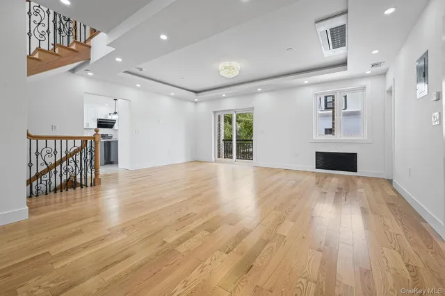 a view of a livingroom with furniture wooden floor and windows